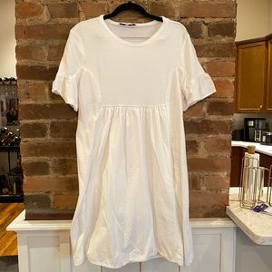 White women’s baby doll dress size medium. Mixed materials.